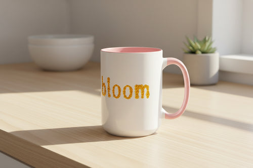 "bloom" floral text Coffee Mug | sunflower petal typography, white & black accent