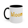 "bloom" floral text Coffee Mug | sunflower petal typography, white & black accent